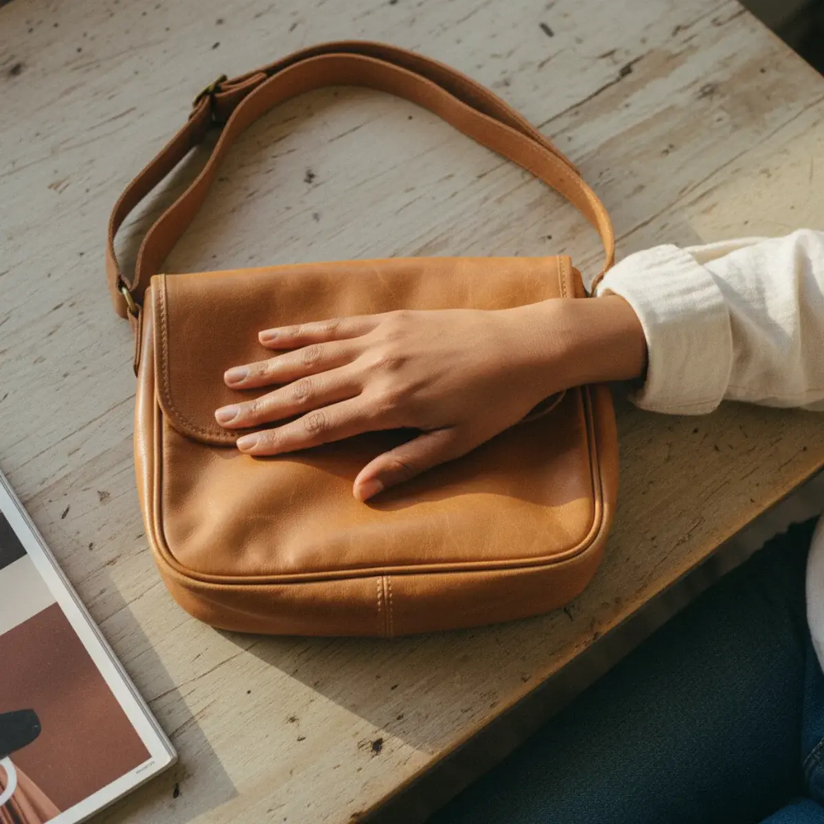 A crossbody for travel: worn across the body toward the front in a crowd, secure and hands-free for sightseeing