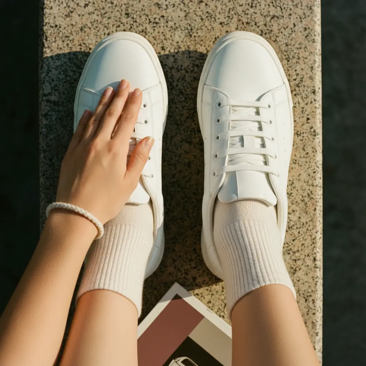 A cute low-effort campus outfit: tailored joggers, a flattering oversized knit, and clean slip-on sneakers