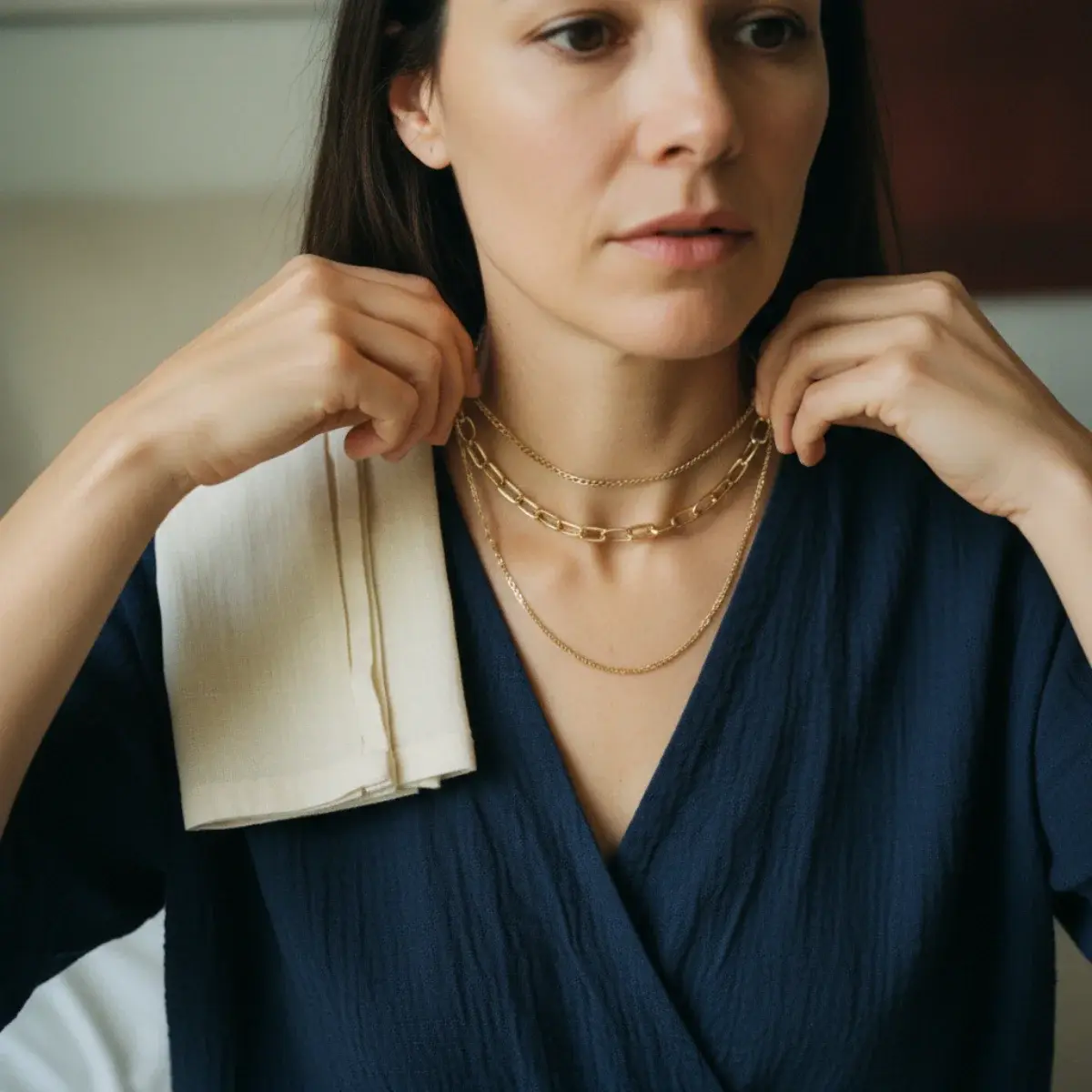 A jewellery capsule: delicate necklaces, stud and hoop earrings, a watch, simple rings, and one or two statement pieces