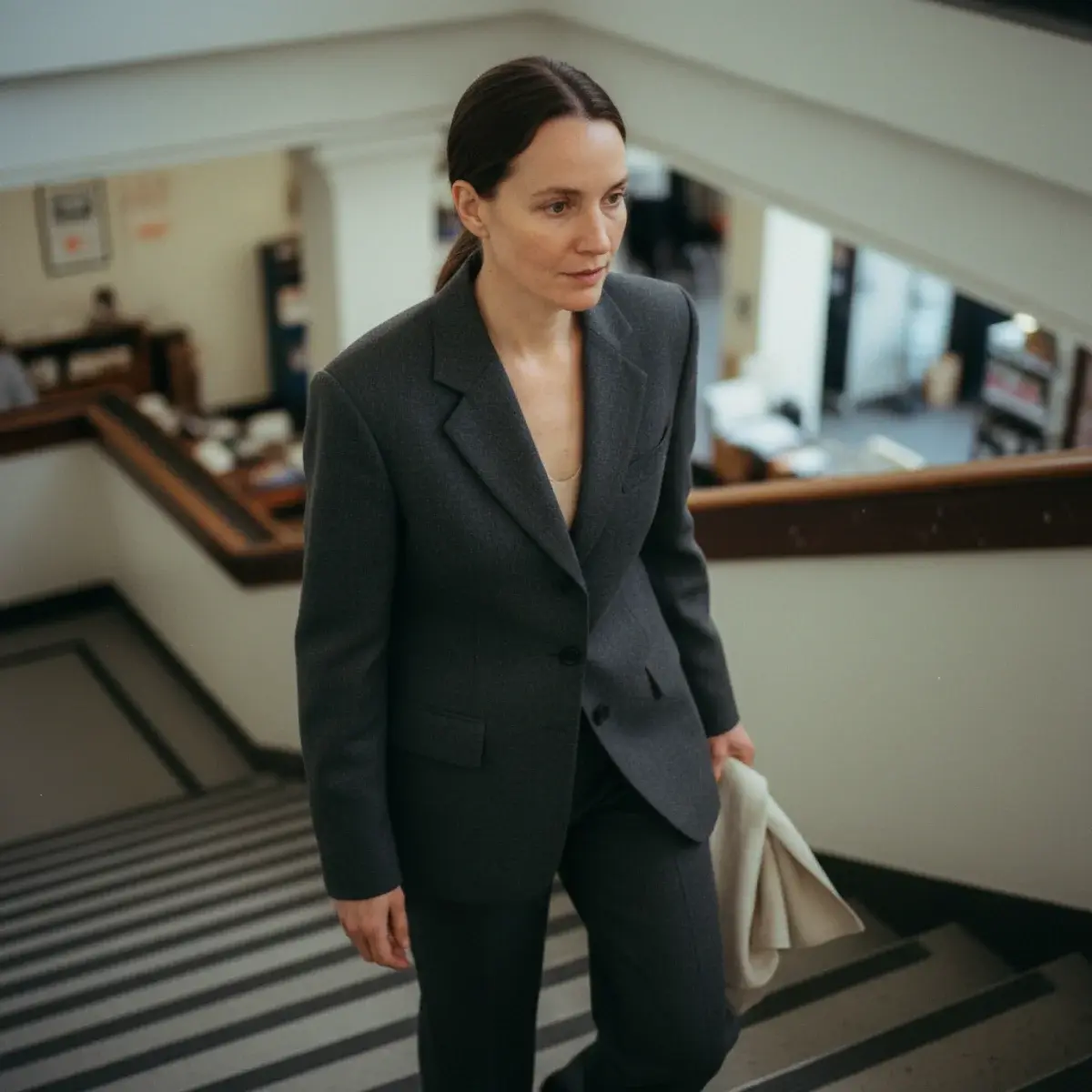 A five-piece interview capsule: navy blazer, white shirt, coordinating blouse, tailored trousers, knee skirt, leather shoes