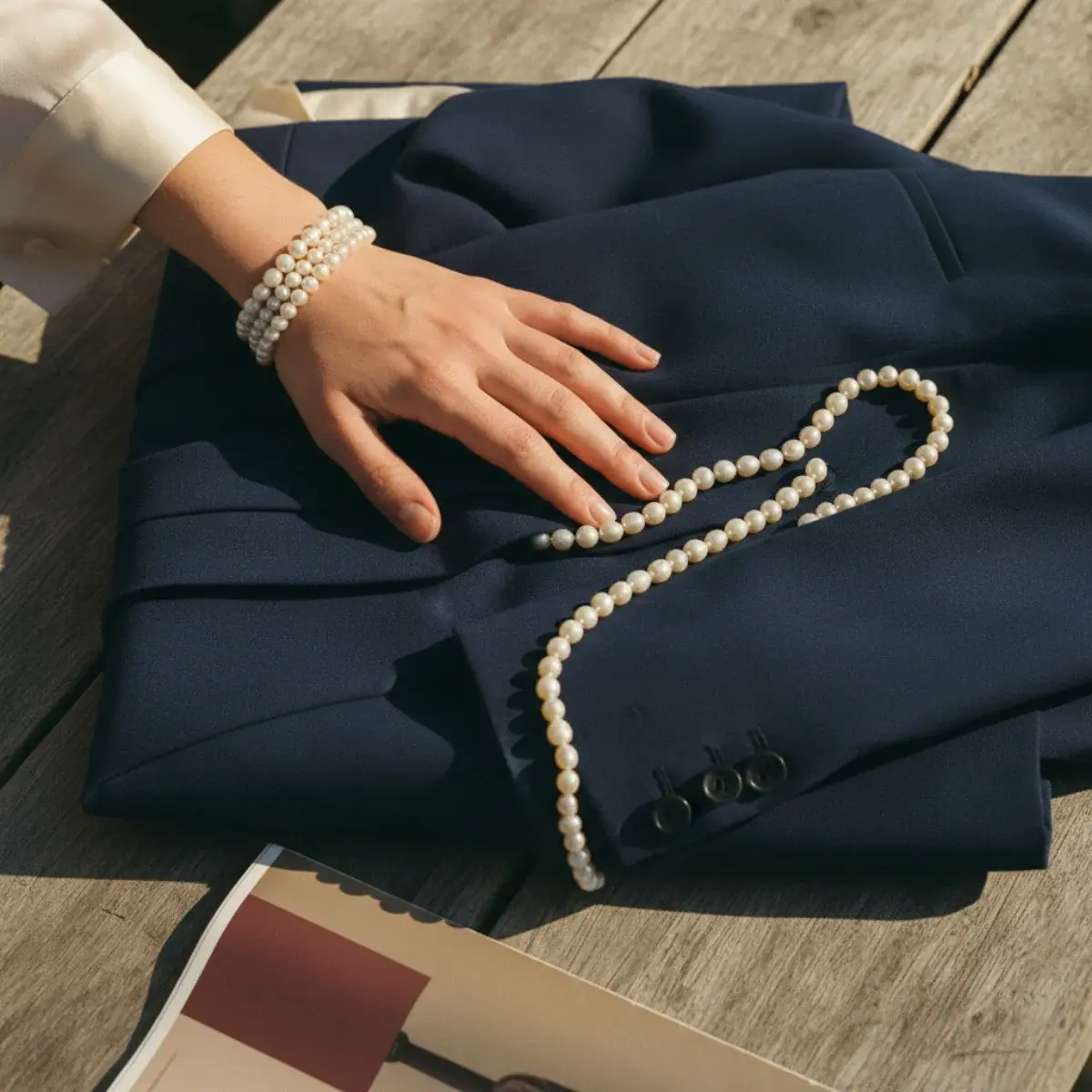 Pearl work outfits: pearl studs with tailored separates, a pearl pendant with a knit and trousers, pearl drops with a silk blouse