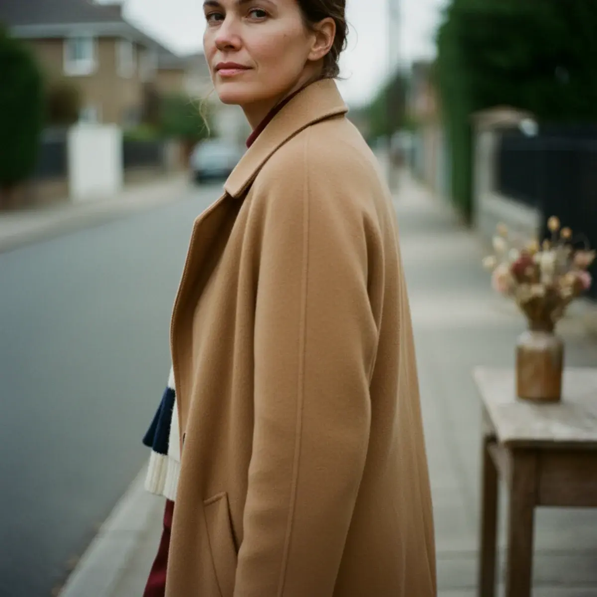 Quiet luxury pieces across price tiers: a luxury cashmere coat beside high-street neutral knitwear