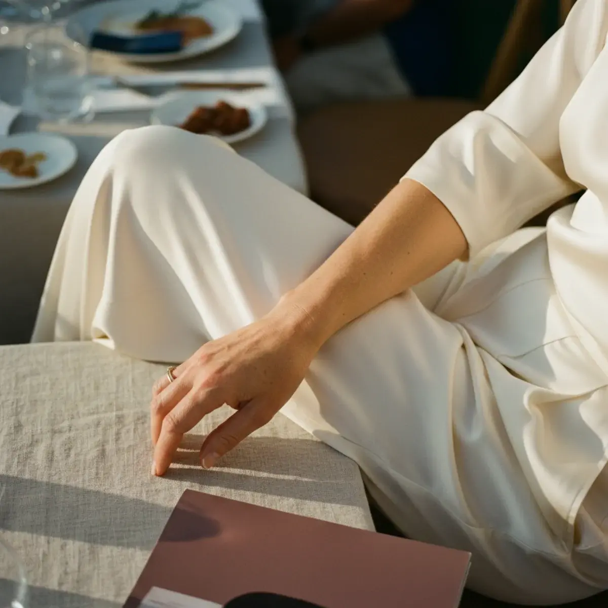 Four seasonal wedding guest looks: spring chiffon, summer linen, fall jewel-tone midi, winter velvet