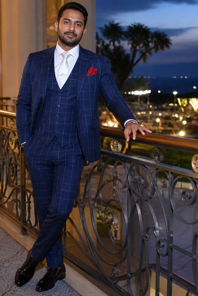 Navy and white check three-piece suit with white shirt and red silk pocket square, brown shoes